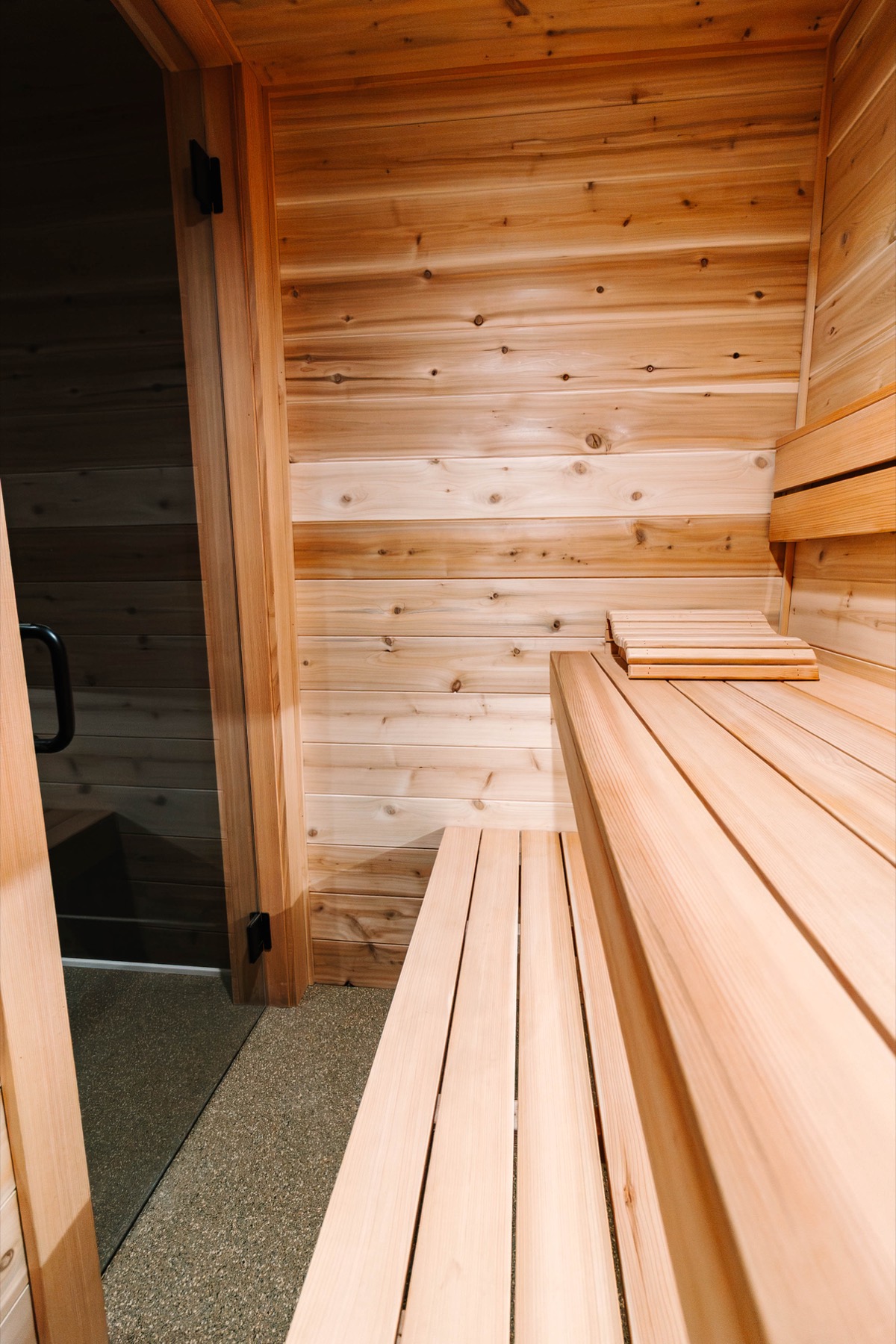Bright cedar sauna bench corner in warm light